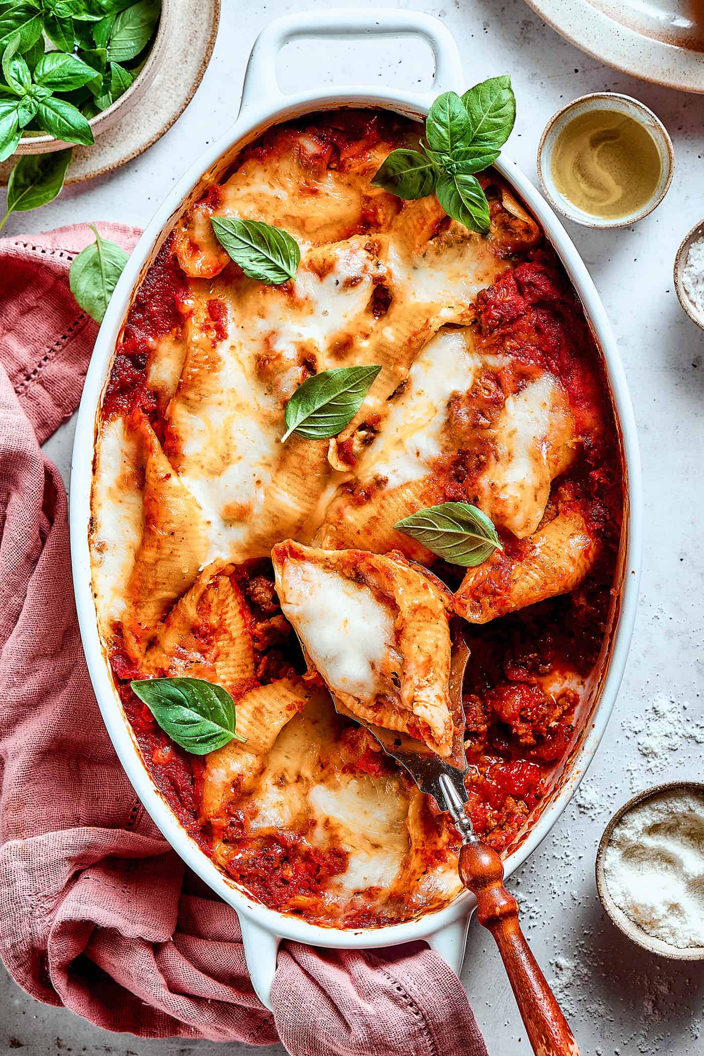 overhead photo of shell pasta stuffed with meat and cheese in a baking dish