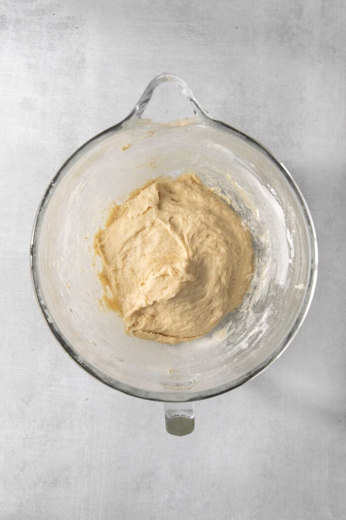 Sweet and pillowy Caramel Rolls make any morning special! Yeast dough and homemade caramel sauce make the ultimate breakfast treat. Dough for caramel rolls is formed in a glass bowl.