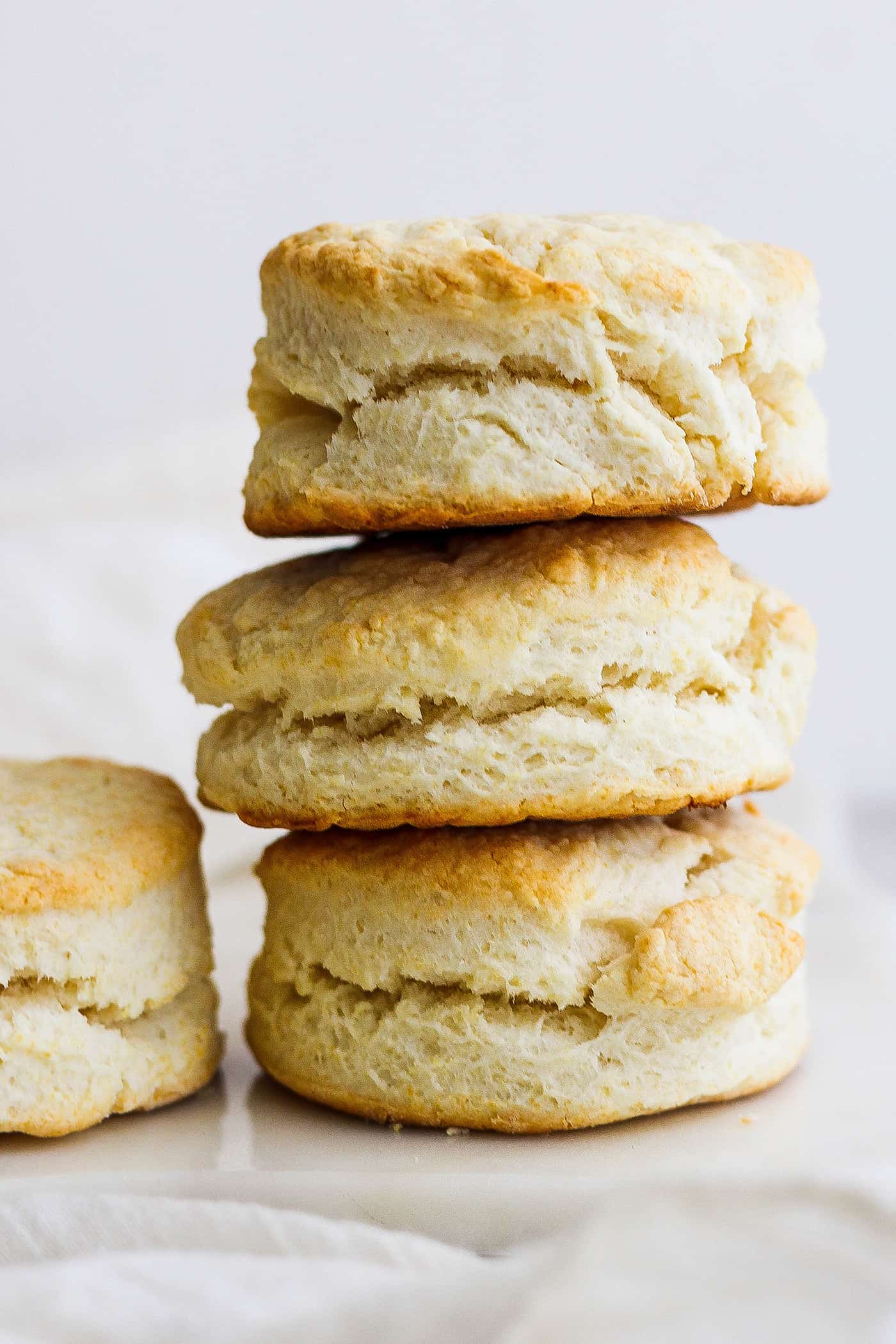Rich, tender Cream Biscuits need just 3 simple ingredients and 15 minutes to make! Serve them with brunch or a hot bowl of homemade soup. A stack of three cream biscuits.