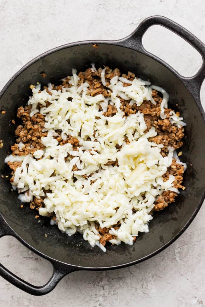 Creamy and just a little spicy, Queso Fundido is an easy, go-to dip! Melted cheese and chorizo are topped with fresh tomatoes and jalapeno. Cooked chorizo is topped with a layer of shredded oaxaca cheese.