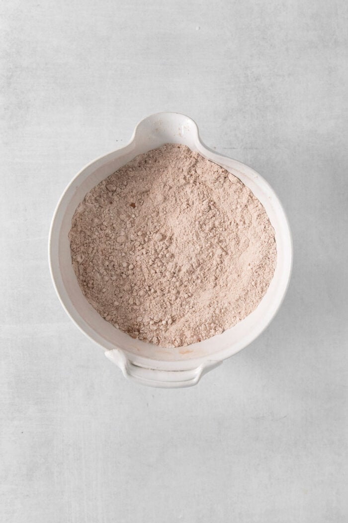 These Red Velvet Cookies are soft and chewy, with a crisp sugar coating and a hint of cocoa and vanilla for flavor. Dry ingredients in a bowl for red velvet cookies.