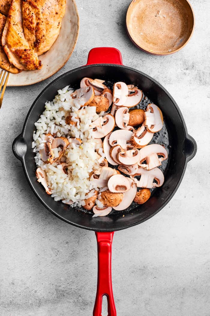 Creamy Chicken Madeira pairs tender chicken breasts with bright asparagus in a rich sauce. Add savory sautéed mushrooms and sweet wine. Shallots and sliced mushrooms in a skillet.