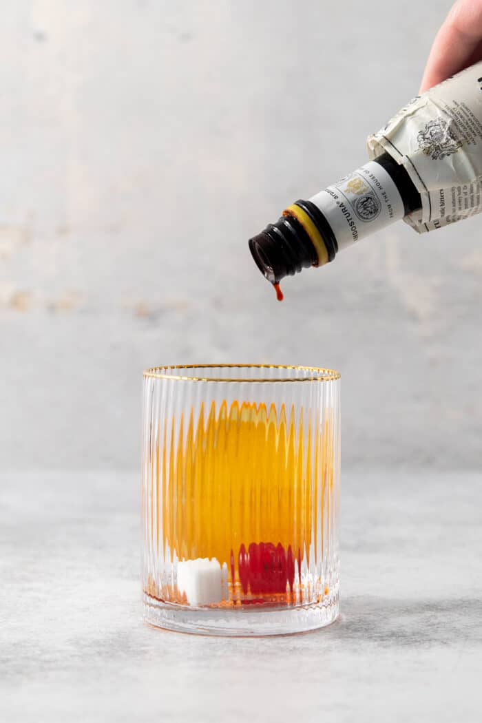 Make a Brandy Old Fashioned for a twist on an Old Fashioned Cocktail! You'll use brandy, a dash of bitters, and orange slices.