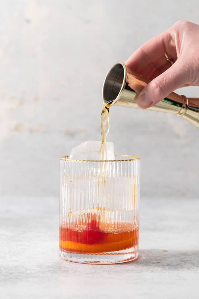 Make a Brandy Old Fashioned for a twist on an Old Fashioned Cocktail! You'll use brandy, a dash of bitters, and orange slices. Brandy is added to a glass to make a brandy old fashioned.