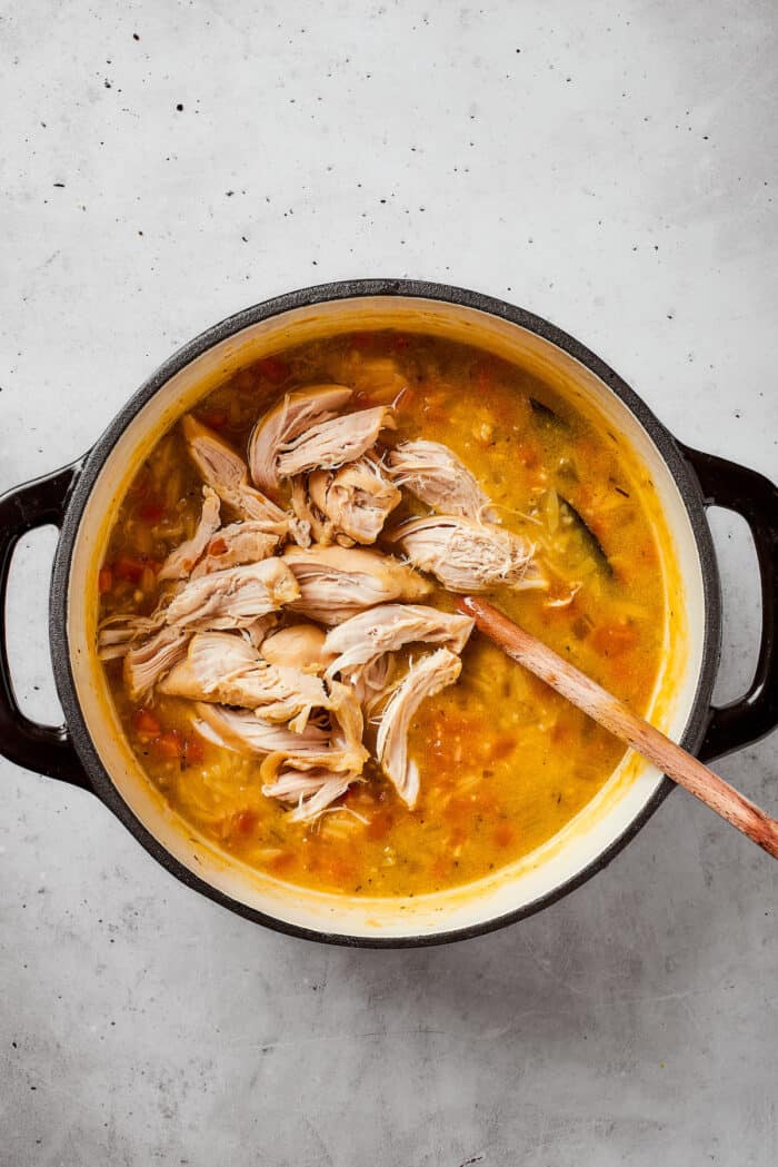 Greek-inspired Lemon Chicken Orzo Soup is fragrant with garlic and packed with tender chicken, vegetables, and delicate orzo pasta. Shredded chicken is added back into the soup pot.