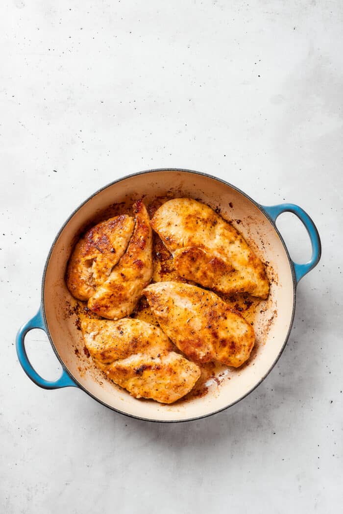 This juicy and tender Lemon Pepper Chicken recipe punches up ordinary chicken with a burst of bright, fresh lemon and a simple sauce. The chicken starts to brown in the dutch oven.