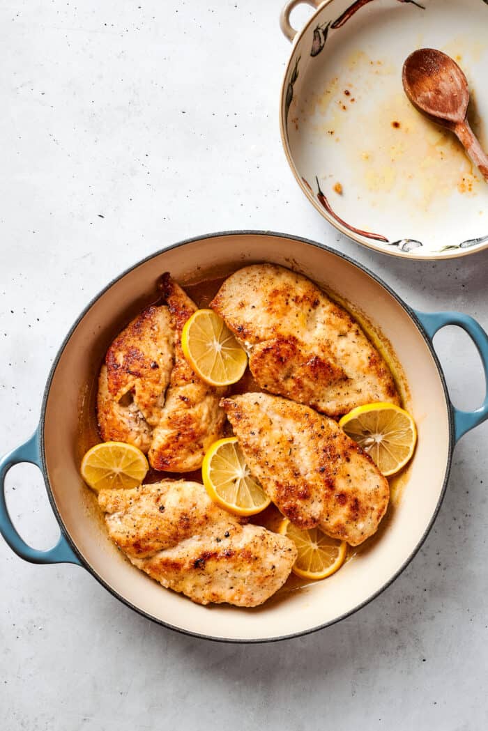 This juicy and tender Lemon Pepper Chicken recipe punches up ordinary chicken with a burst of bright, fresh lemon and a simple sauce. The cooked chicken breast is added back to the sauce in the pot.
