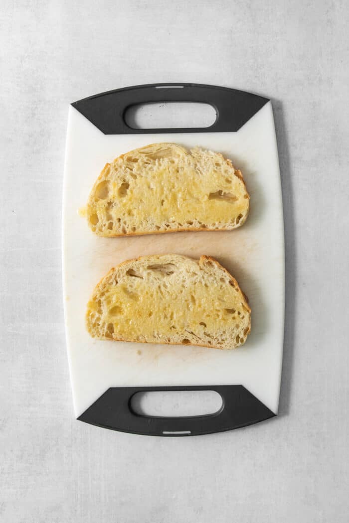 Air Fryer Grilled Cheese | Easy Cheesy Grilled Cheese Recipe! Melted butter with garlic powder is brushed on bread for air fryer grilled cheese.