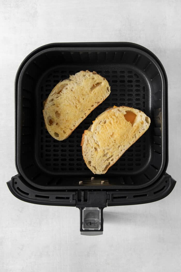 Air Fryer Grilled Cheese | Easy Cheesy Grilled Cheese Recipe! Two grilled cheese sandwiches cook in the air fryer.