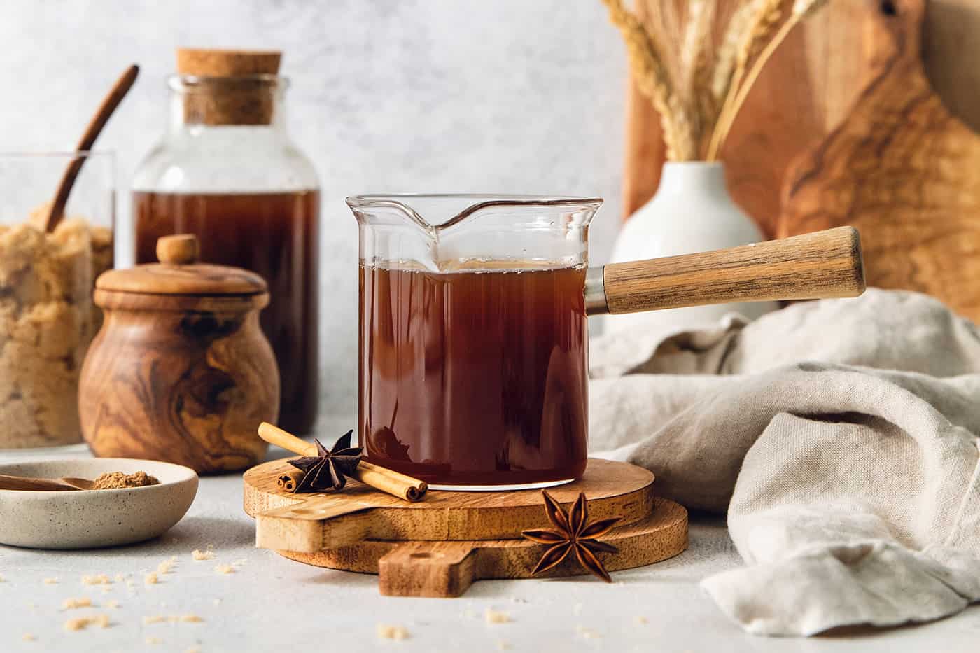 homemade chai concentrate in a clear pot