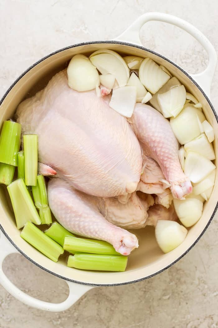 This homemade Chicken Noodle Soup is an easy classic with from-scratch chicken broth loaded with tender chicken, vegetables, and egg noodles. A whole chicken cooks in a pot of water with onions and celery to make chicken stock.