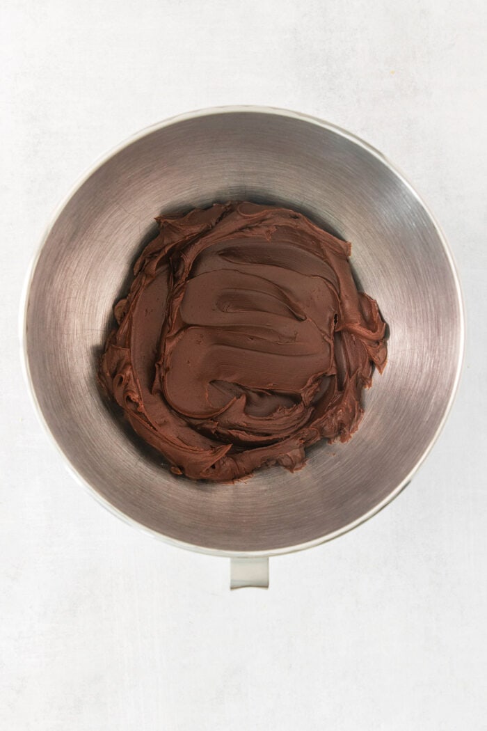 A metal bowl holds chocolate ganache.