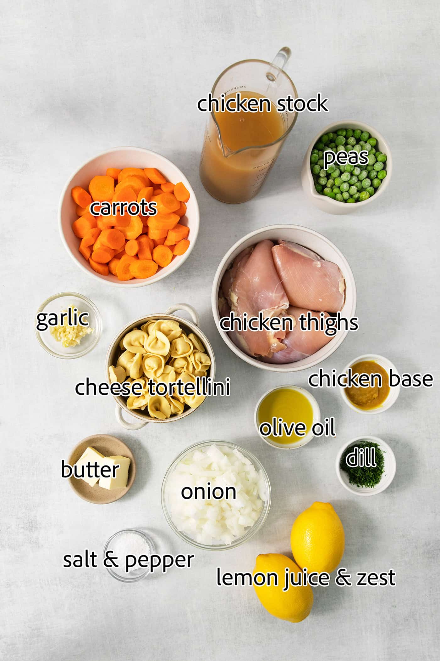 Cheesy tortellini pockets are the stars of this Lemon Chicken Tortellini Soup that also features a lemony broth packed with shredded chicken. The ingredients for lemon chicken tortellini soup are shown: chicken, carrots, broth, peas, olive oil, garlic, herbs, salt and pepper, lemon, tortellini.