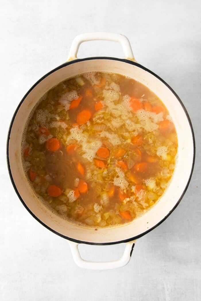 Cheesy tortellini pockets are the stars of this Lemon Chicken Tortellini Soup that also features a lemony broth packed with shredded chicken. Carrots and onions are shown in the broth