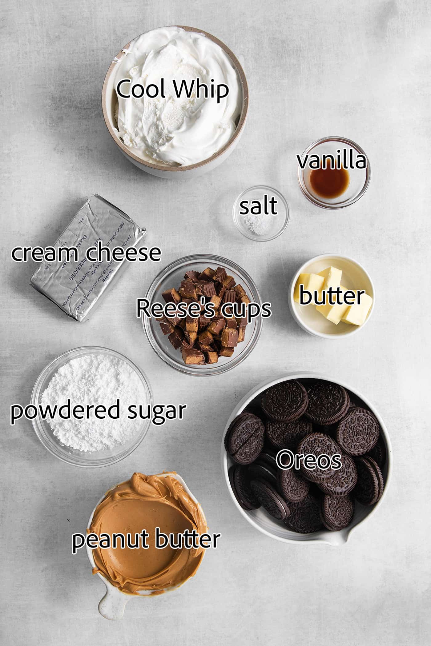This no-bake Reese’s Pie features a crisp Oreo crust and a creamy peanut butter filling finished with whipped topping and Reese’s cups. The ingredients for Reeses pie are shown: peanut butter, cream cheese, peanut butter cups, whipped topping, butter, Oreos, salt, vanilla, powdered sugar.