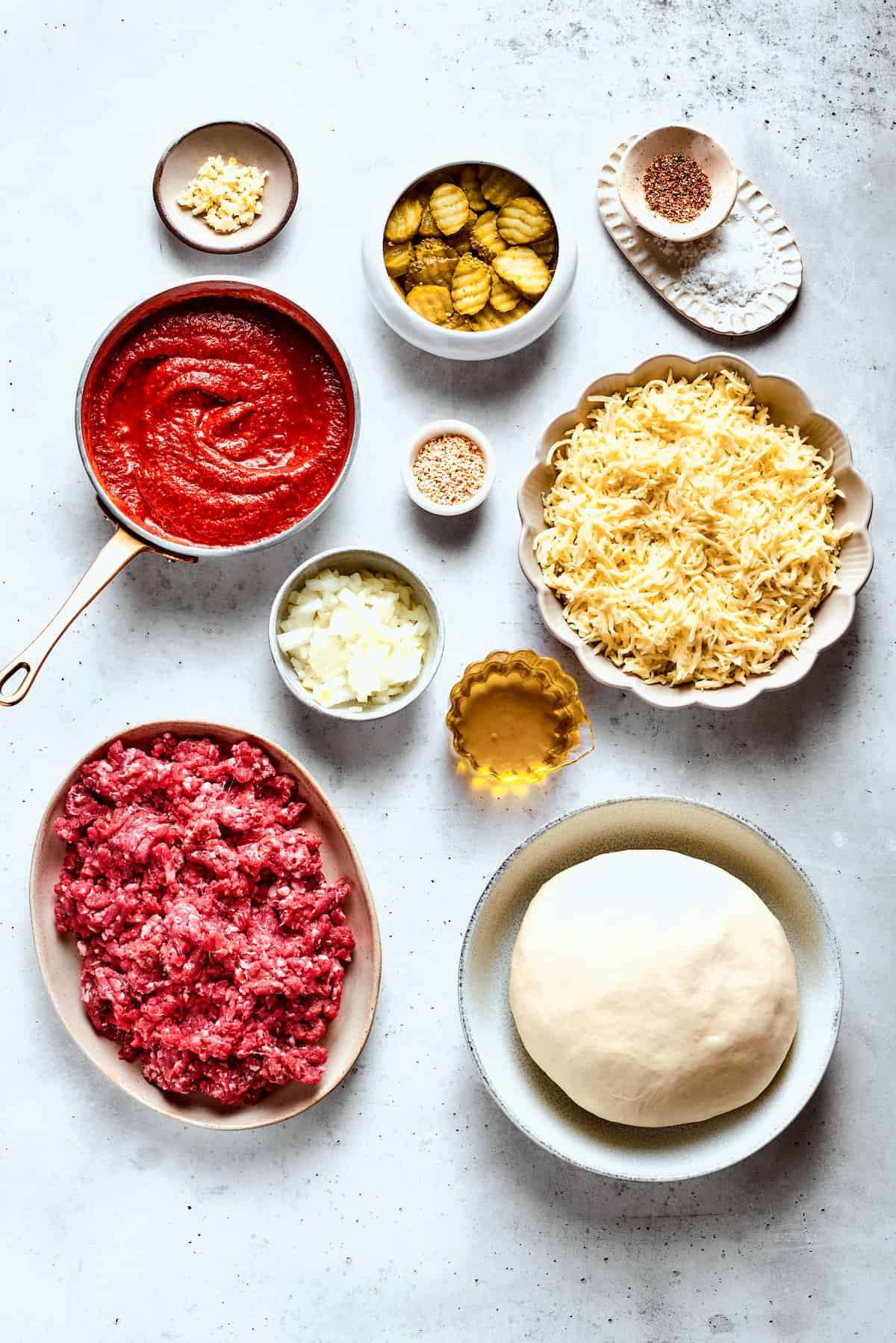 This Cheeseburger Pizza recipe turns your favorite burger into pizza! Top homemade dough with pizza sauce, ground beef, cheese, and pickles. Ingredients for cheeseburger pizza: sauce, ground beef, cheese, pizza dough, pickles, onion, garlic, salt and pepper, olive oil.