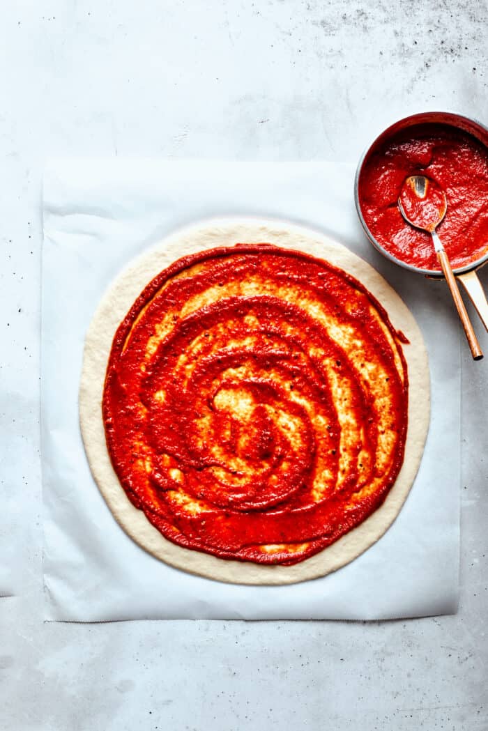 This Cheeseburger Pizza recipe turns your favorite burger into pizza! Top homemade dough with pizza sauce, ground beef, cheese, and pickles. Pizza sauce is spread over the dough.