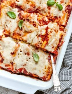 lasagna roll ups in a white baking dish