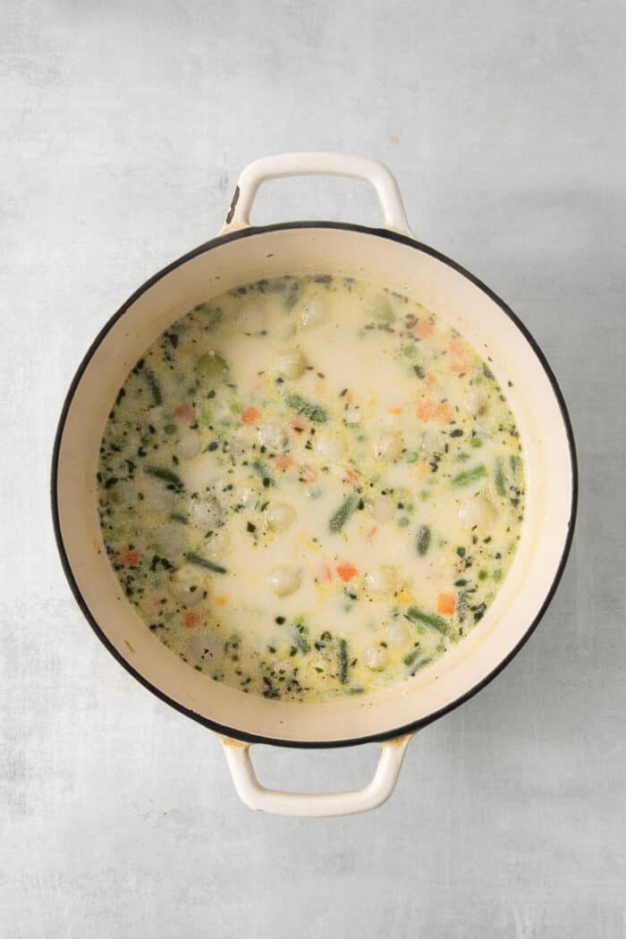 This homemade Chicken Pot Pie Soup recipe features a creamy broth that’s loaded with chicken and vegetables and topped with biscuits. Half and half is added to the pot of soup.