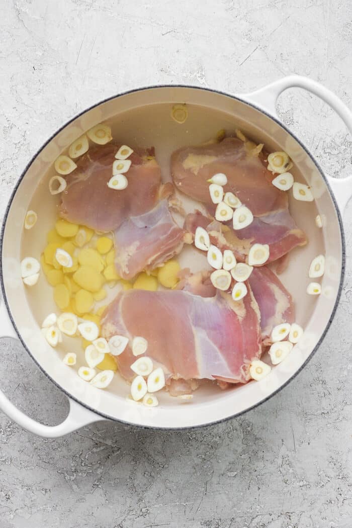 This zesty Chicken Ginger Soup recipe is brimming with fresh ginger, garlic, and lemon plus sweet potatoes, shredded chicken, and pasta. Chicken thighs cook in water with garlic and ginger.
