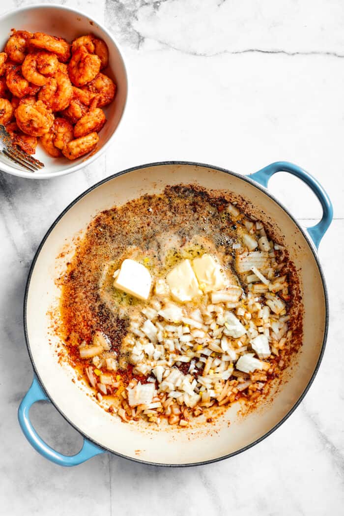 This beautiful, smoky-spicy Cajun Shrimp Pasta recipe folds juicy shrimp into a creamy, Louisiana-inspired sauce. Butter is mixed in to the pot.