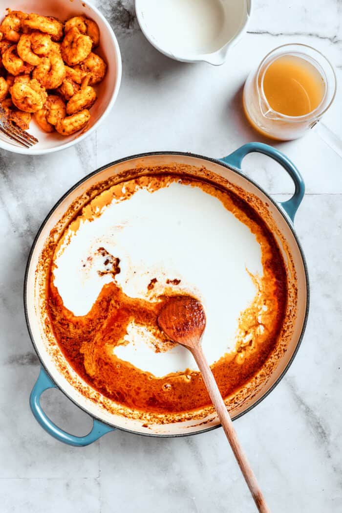 This beautiful, smoky-spicy Cajun Shrimp Pasta recipe folds juicy shrimp into a creamy, Louisiana-inspired sauce. Cream is added to the red sauce.