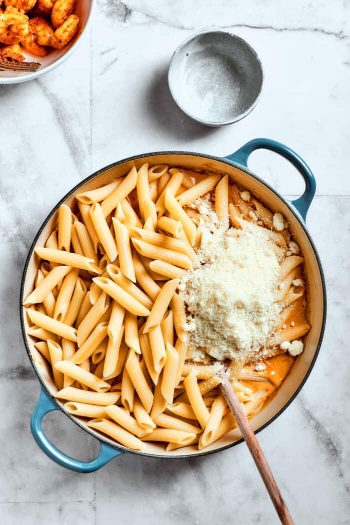 This beautiful, smoky-spicy Cajun Shrimp Pasta recipe folds juicy shrimp into a creamy, Louisiana-inspired sauce. Cheese is added to the pasta.
