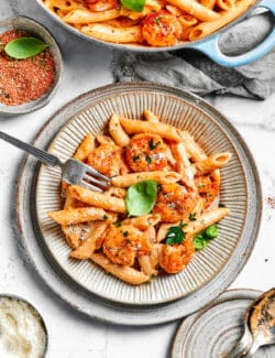 Bowls of cajun shrimp pasta are ready to eat.