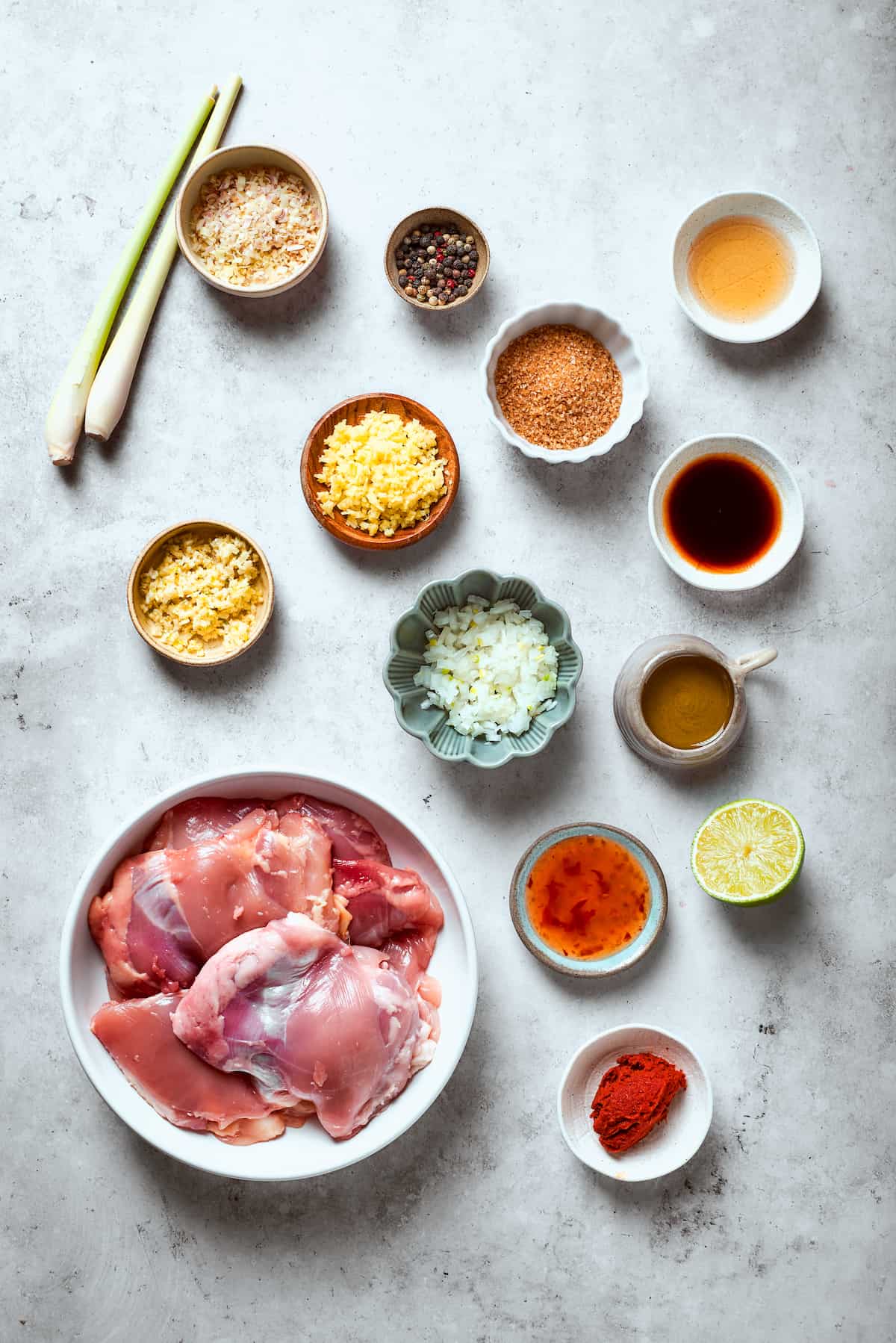 Ingredients for lemongrass chicken are shown: chicken, lemongrass, ginger, garlic, spices.