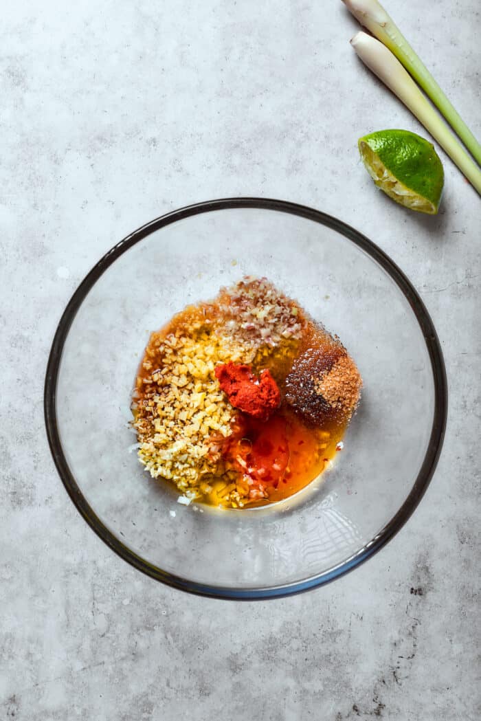The marinade ingredients are placed in a glass bowl.
