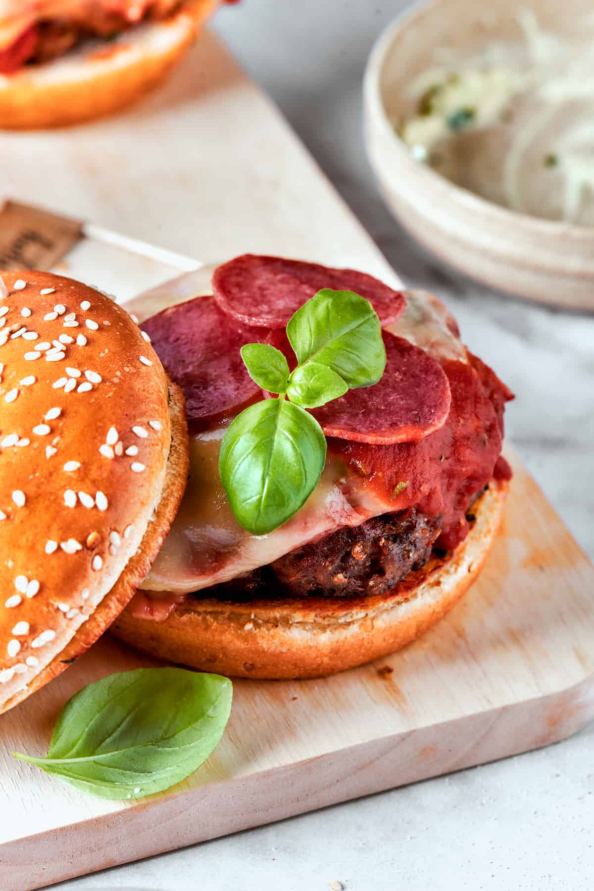 Blend two favorites to make this Pizza Burger recipe! Juicy beef patties are topped with tangy marinara, pepperoni, mozzarella & fresh basil. Pepperoni and fresh basil top a pizza burger patty.