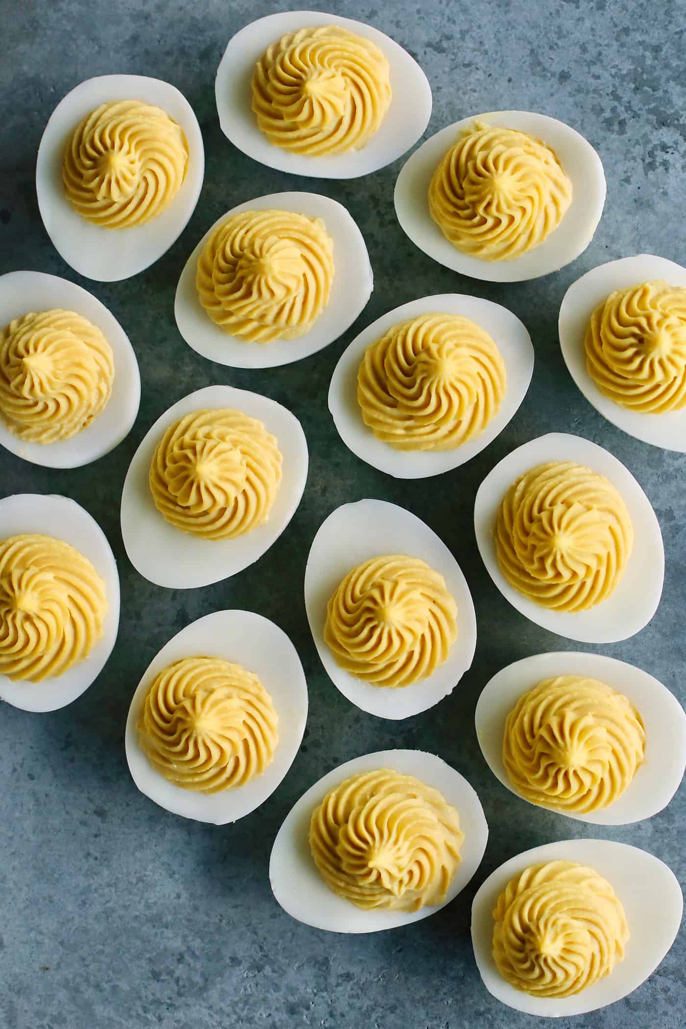 This Classic Deviled Eggs recipe is a beloved appetizer that features an irresistibly creamy and tangy filling made with simple basics. Make this easy deviled eggs recipe as written or try some of my flavorful variation suggestions.