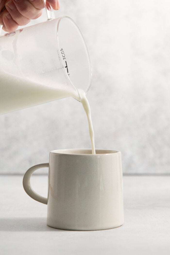This Lavender Latte mixes freshly brewed espresso, oat milk, and a sweet lavender simple syrup to create a copycat Starbucks lavender latte. The oat milk is added to the espresso and lavender simple syrup in the mug.