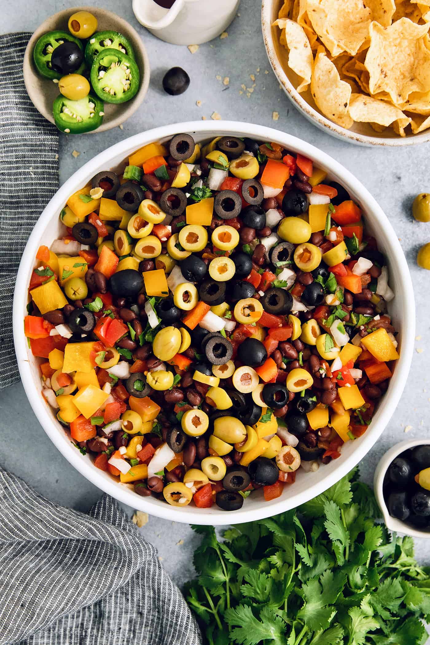 Scoop up this easy, versatile Black Bean Salsa with tortilla chips, dollop a spoonful on top of nachos, or use it as a taco filling! Olives top a big bowl of black bean salsa.