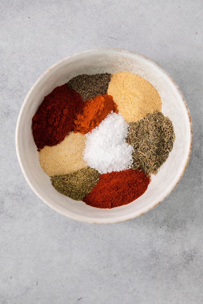 This homemade Blackened Seasoning recipe is rich, earthy, and slightly smoky with the perfect amount of heat! dried spices and herbs in a bowl