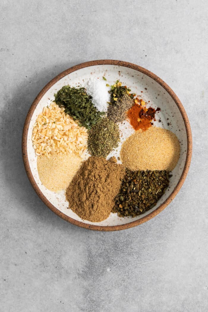 Homemade Green Taco Seasoning is so easy to DIY! It's flavorful, not too spicy, and is perfect in tacos, nachos, quesadillas and more. The spices and seasonings are added to a bowl.