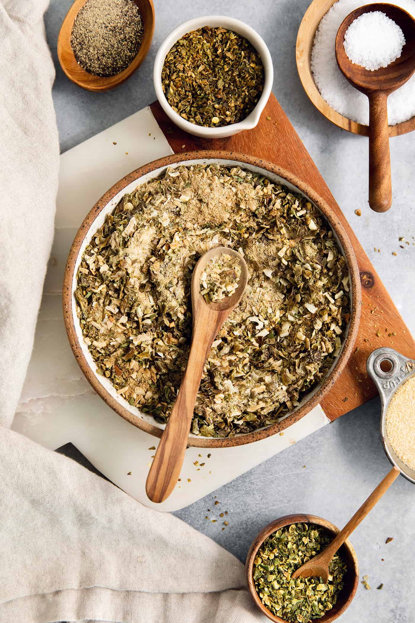 Homemade Green Taco Seasoning is so easy to DIY! It's flavorful, not too spicy, and is perfect in tacos, nachos, quesadillas and more. A big bowl of green taco seasoning with a wooden spoon resting in it.