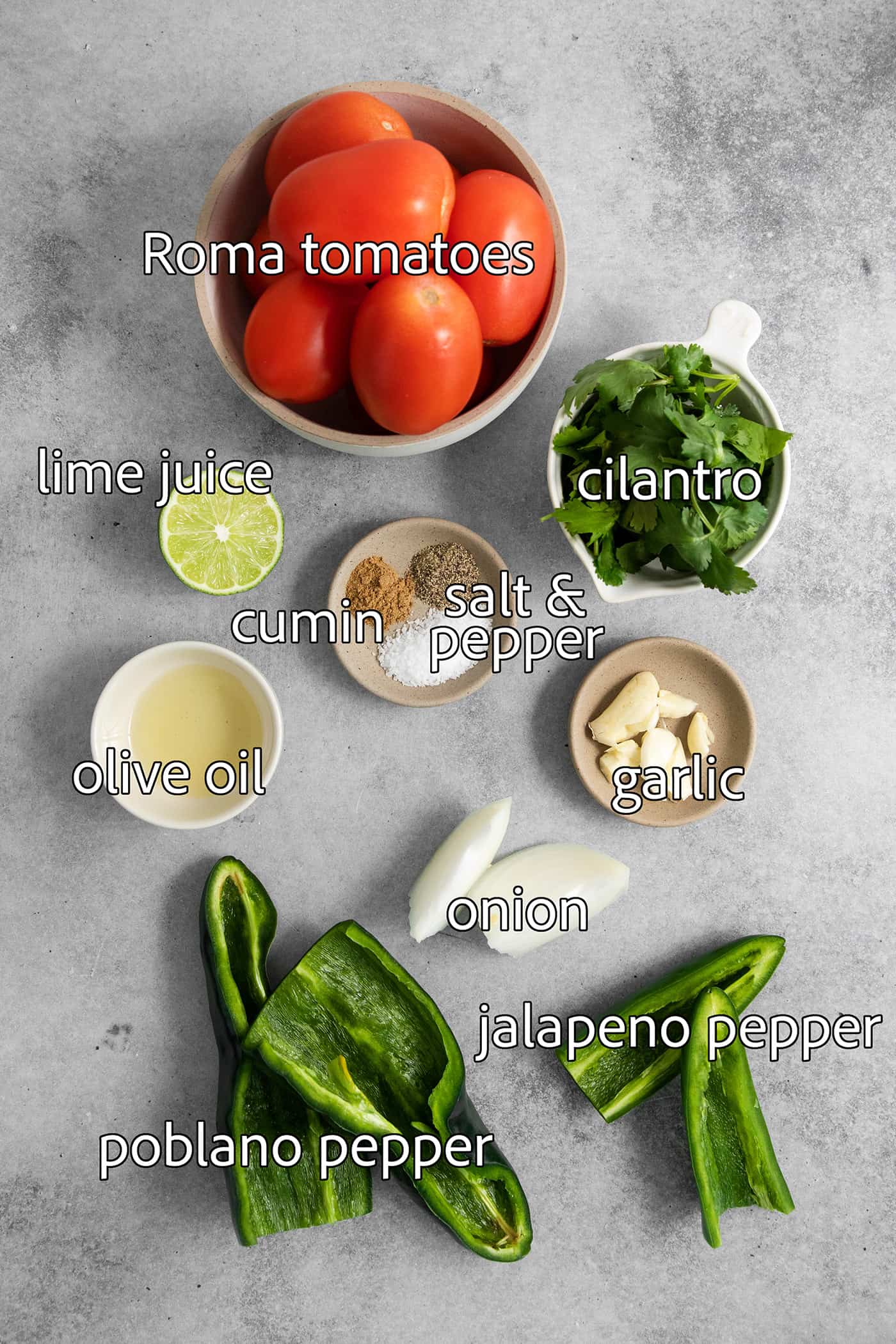 This Warm Salsa recipe is perfectly spiced and juicy, with a pop of lime juice for sweetness. Enjoy it with tacos, quesadillas, & chips. Warm salsa ingredients are labelled and portioned out: cumin, salt and pepper, olive oil, lime juice, cilantro, onion, garlic, tomatoes, peppers.