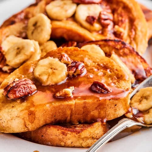 up-close photo of French toast with bananas foster sauce