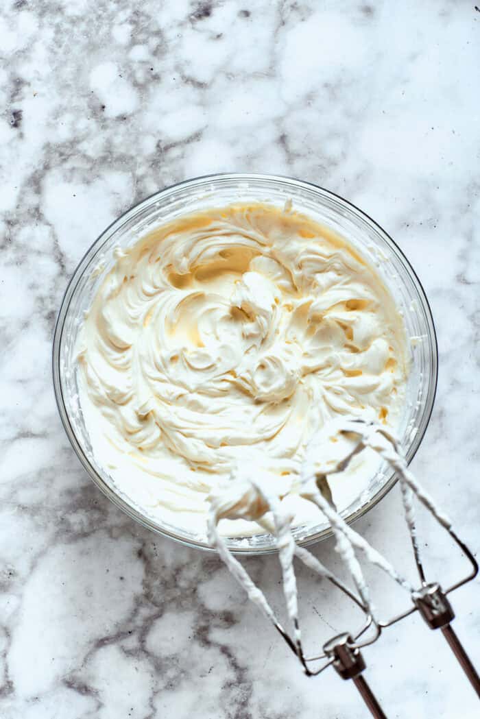 This cold and creamy Dill Pickle Dip is packed with crunchy pickles and a mix of cream cheese and sour cream. The sour cream and cream are beaten together.