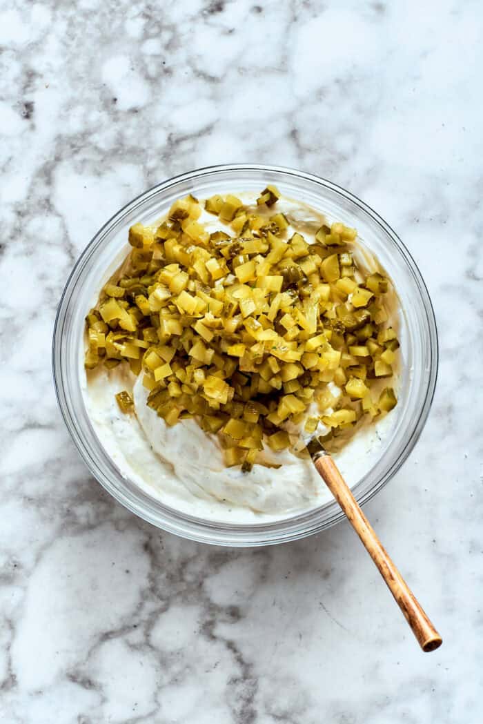 This cold and creamy Dill Pickle Dip is packed with crunchy pickles and a mix of cream cheese and sour cream. Chopped dill pickles are stirred into the dip.