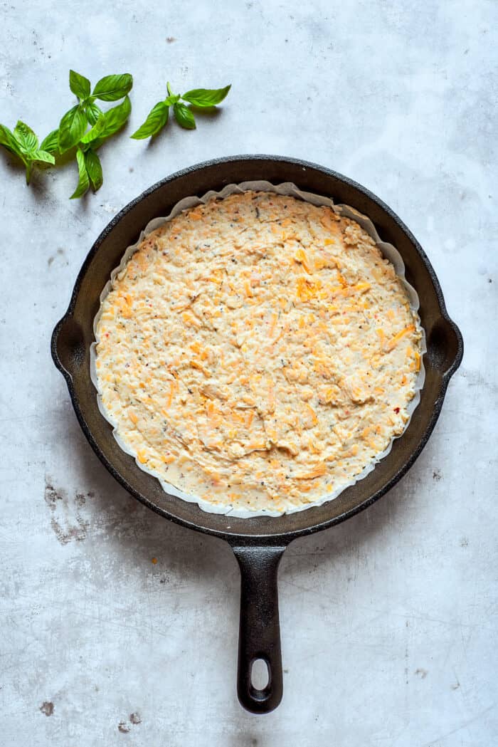The dip is spread into a cast iron pan.