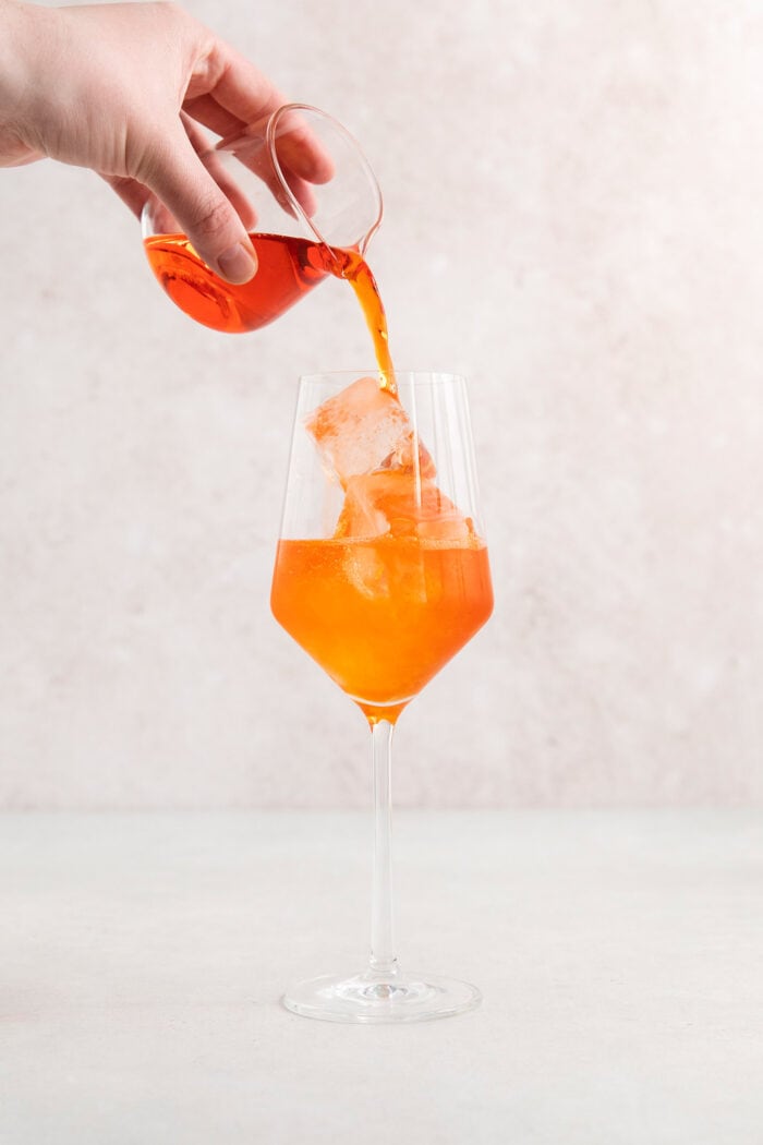 This classic Aperol spritz recipe is my take on an Italian aperitivo and makes a refreshing cocktail out of just four ingredients. Aperol is poured into the glass.