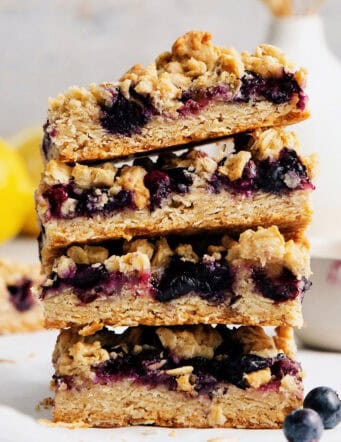 A stack of four blueberry crumble bars.