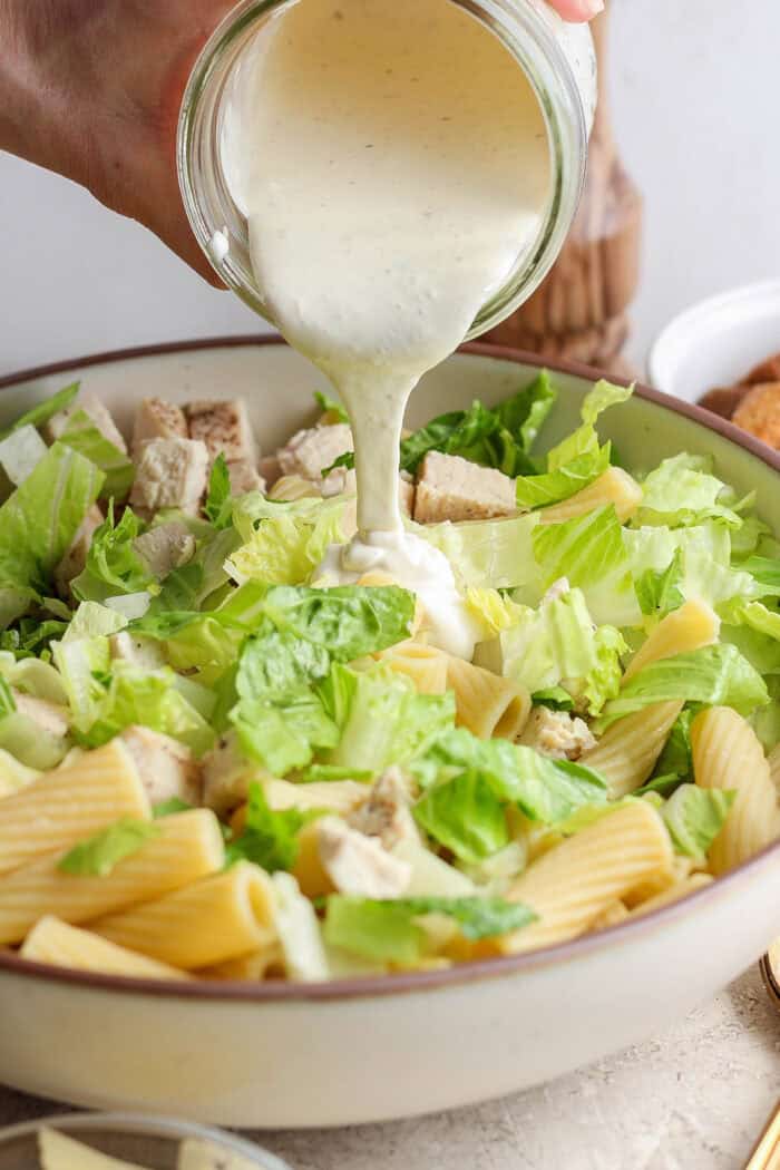 Dressing is poured into the salad bowl.
