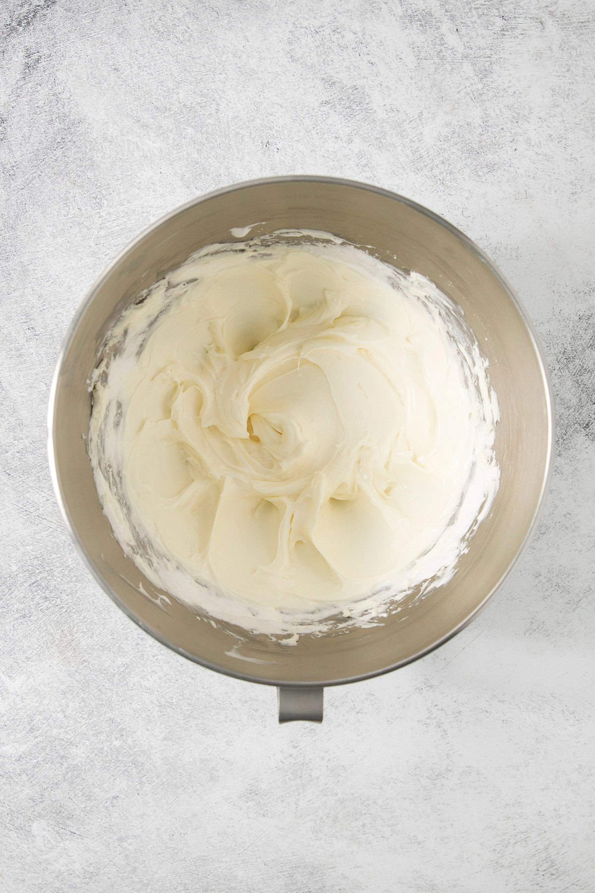This 2-ingredient Fruit Dip is the perfect fluffy and creamy dessert dip featuring tangy cream cheese swirled with marshmallow creme. The cream cheese and marshmallow fluff are beaten in a bowl.