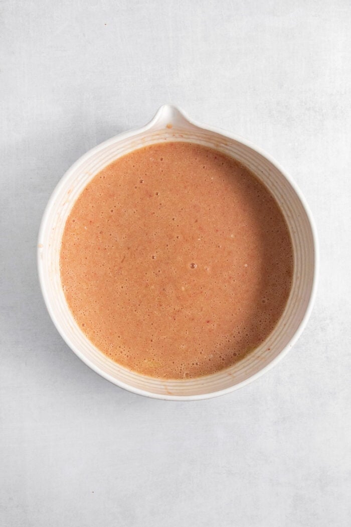 The wet mix for strawberry brownies is combined in a bowl.