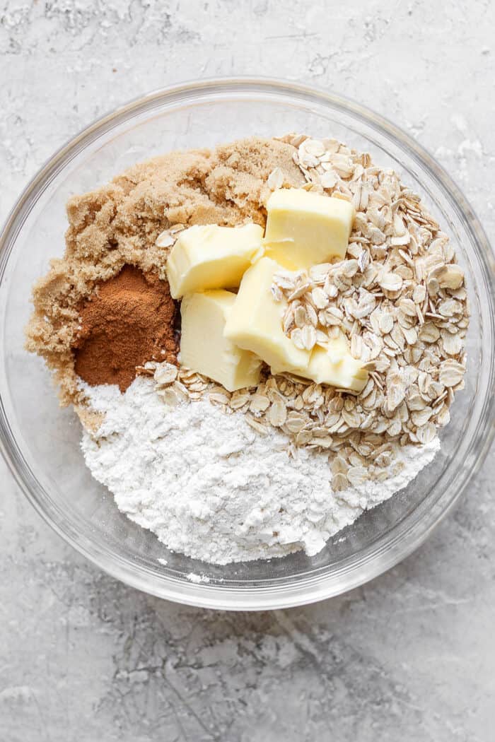 flour, brown sugar, cinnamon, oats, and butter in a clear bowl