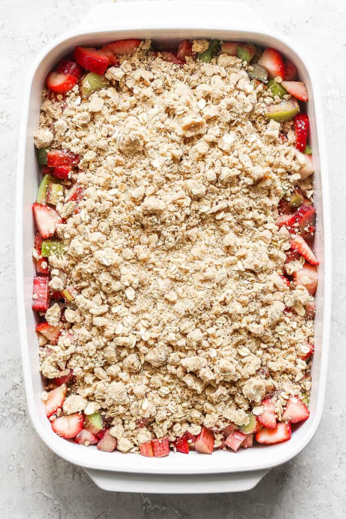 the crisp topping sprinkled over the chopped strawberries and rhubarb in the baking dish
