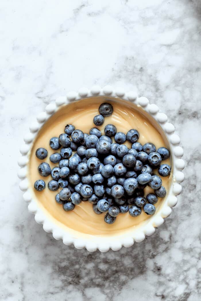 Fresh blueberries are added to the cheesecake base.